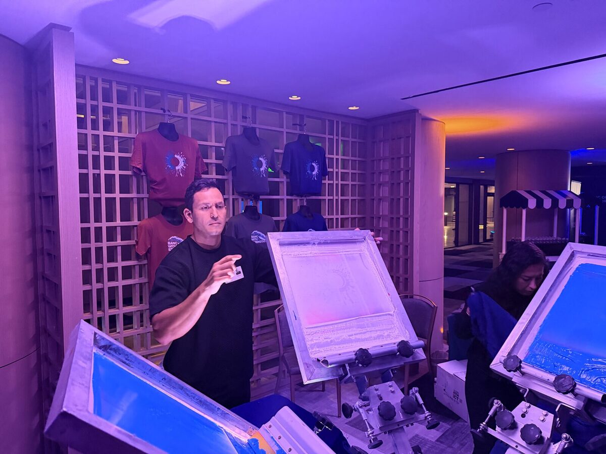 Hat bar station set up alongside branded tees at a corporate activation